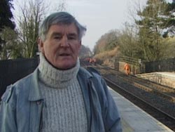 man being interviewed at railway station