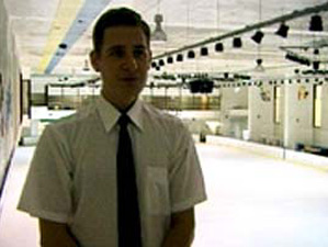 Man standing in front of bright ice rink
